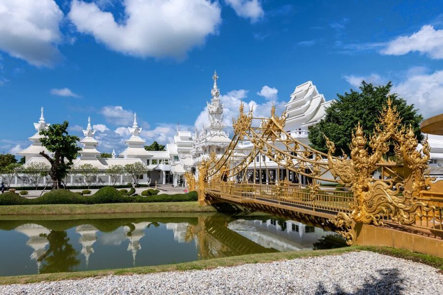 From Chiang Mai: Chiang Rai's Temples Exploration Day Trip - The Red Temple: bright Thai spiritual art and story scenes